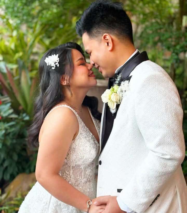 A couple sharing a quiet moment in a garden, at a wedding planned by GO Events.
